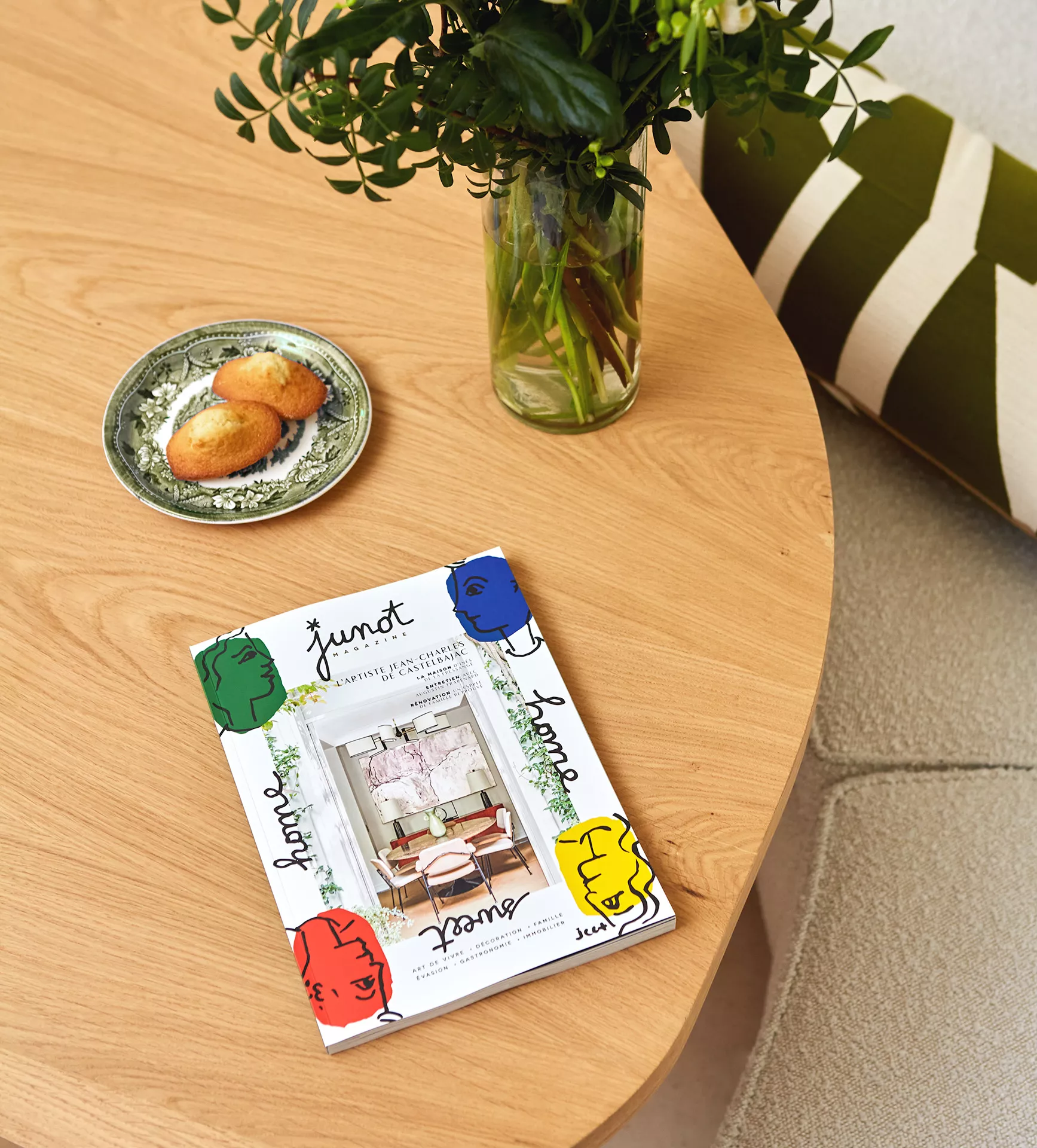 Closed Junot magazines on a wooden coffee table