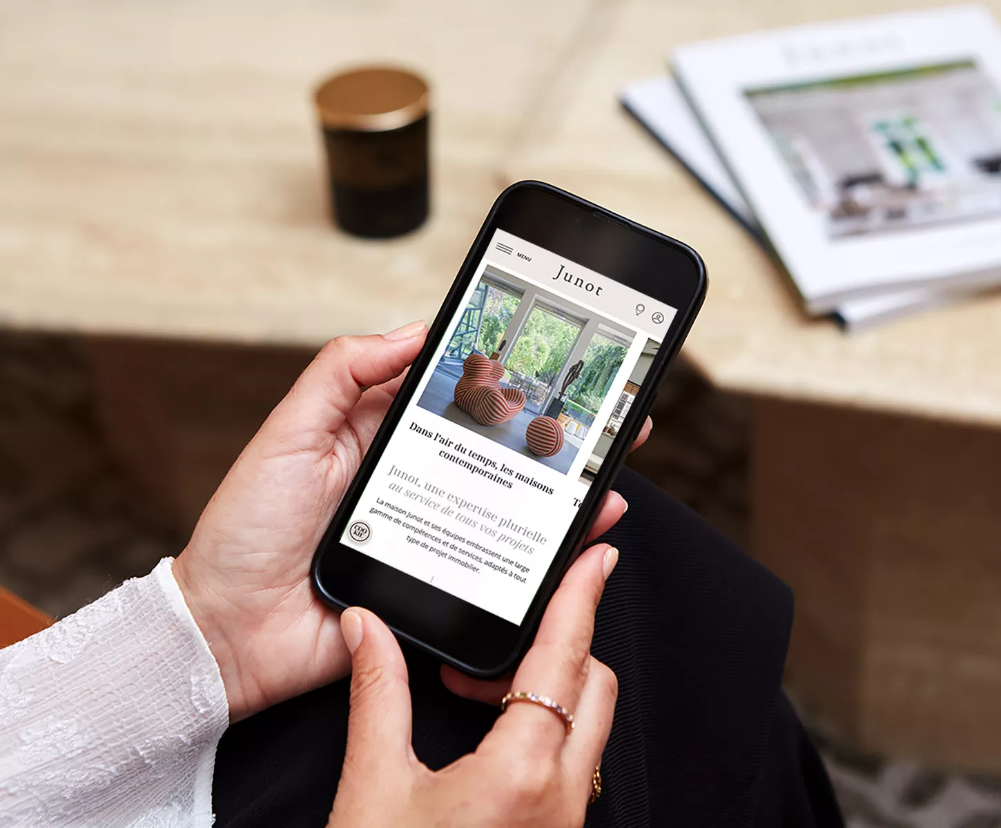 Junot client holding a mobile phone and browsing the Junot real estate website