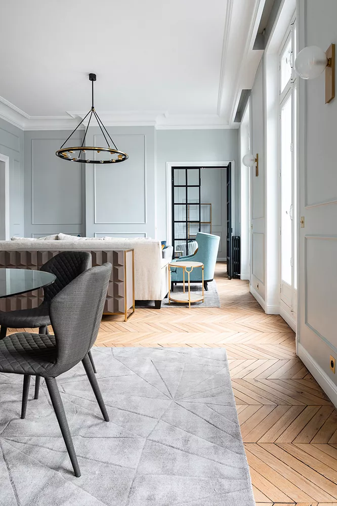 A living room with blue walls in an exceptional apartment sold by Junot Fine Properties Knight Frank