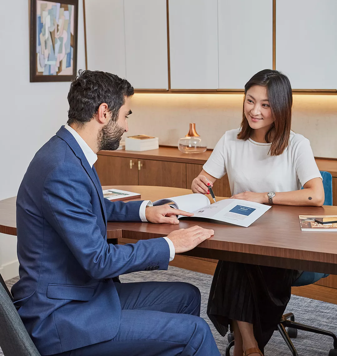 A Junot client discusses his purchase project with a Junot Fine Properties consultant