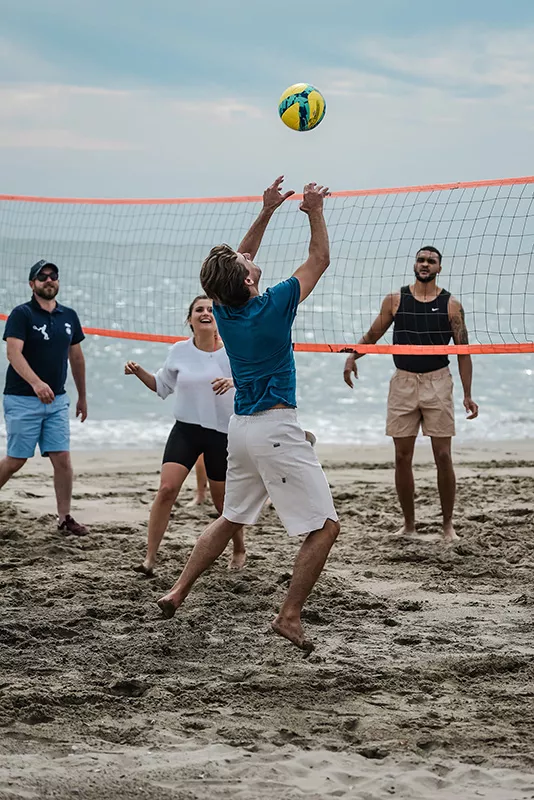 Junot team at a seminar playing volleyball