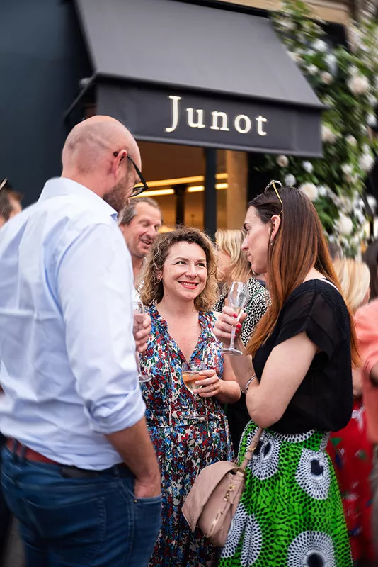 Three Junot consultants discussing in front of a Junot real estate agency