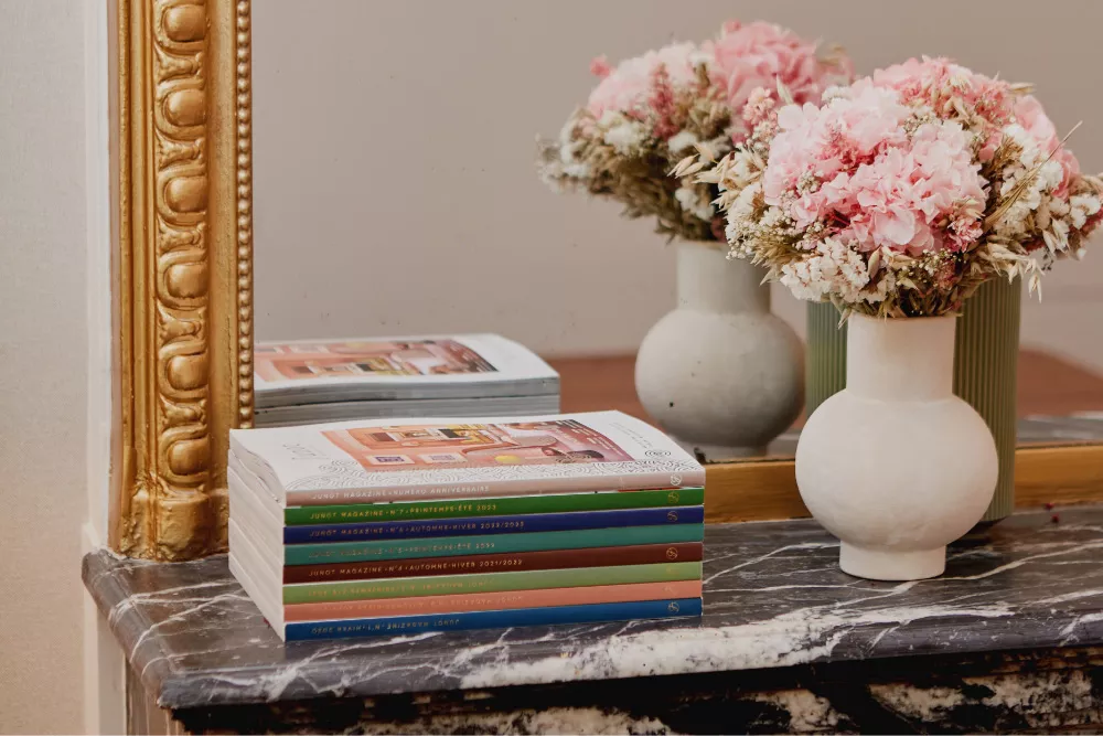 Junot magazine open on a marble table