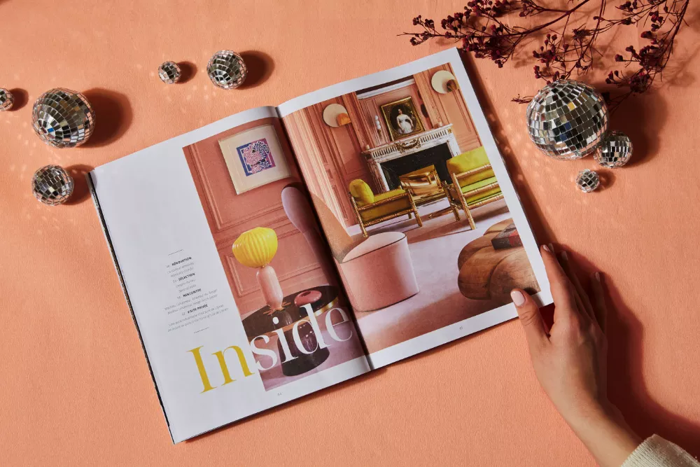 Three Junot magazines on top of each other on a marble table